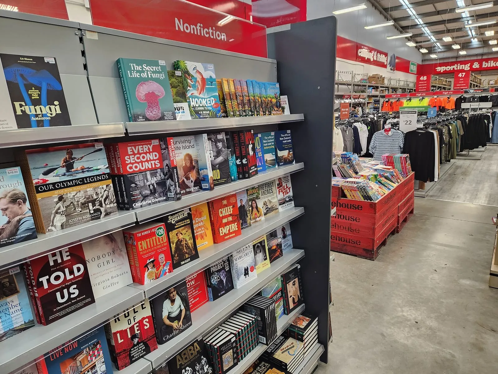 Rayonnages de livres dans une librairie, vus depuis l'allée centrale